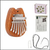 A wooden kalimba thumb piano with metal tines and a storage box, shown next to its loose wires.