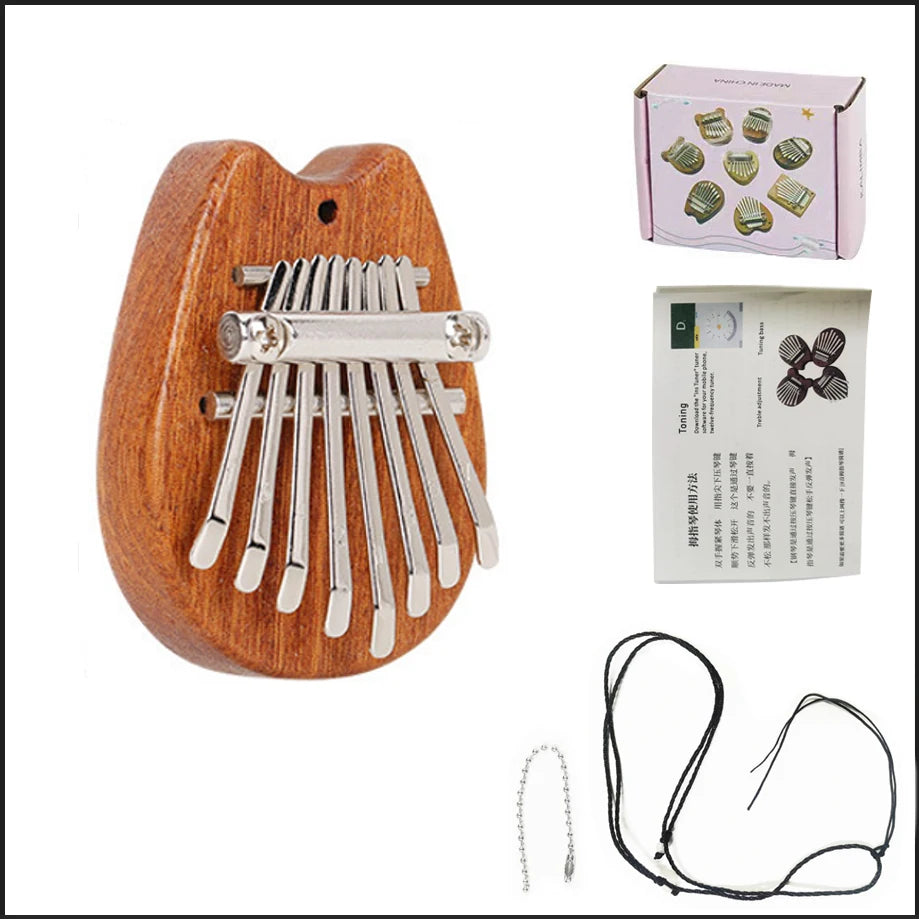 A wooden kalimba thumb piano with metal tines and a storage box, shown next to its loose wires.