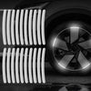 Close-up of a car wheel with reflective strips installed on the rim.