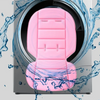 A pink cartoon baby stroller seat cushion is shown inside a washing machine drum surrounded by splashing water.