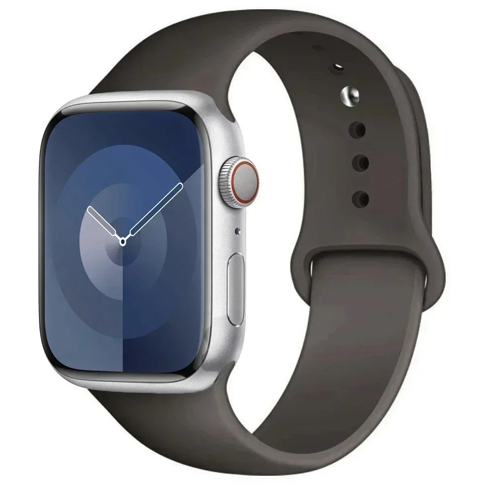 A silver Apple Watch encased in a dark gray silicone sport band.