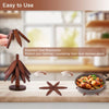 Wooden tree design coasters and folding placemats shown on a wooden table with a pan of food.