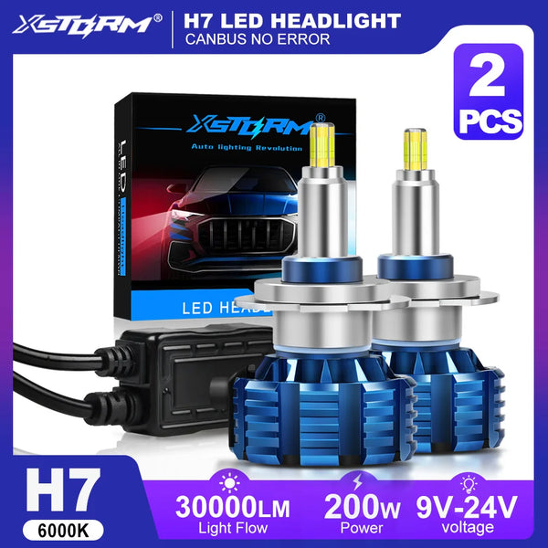 Two XSTORM H7 LED headlight bulbs with blue and silver bases shown next to their packaging.