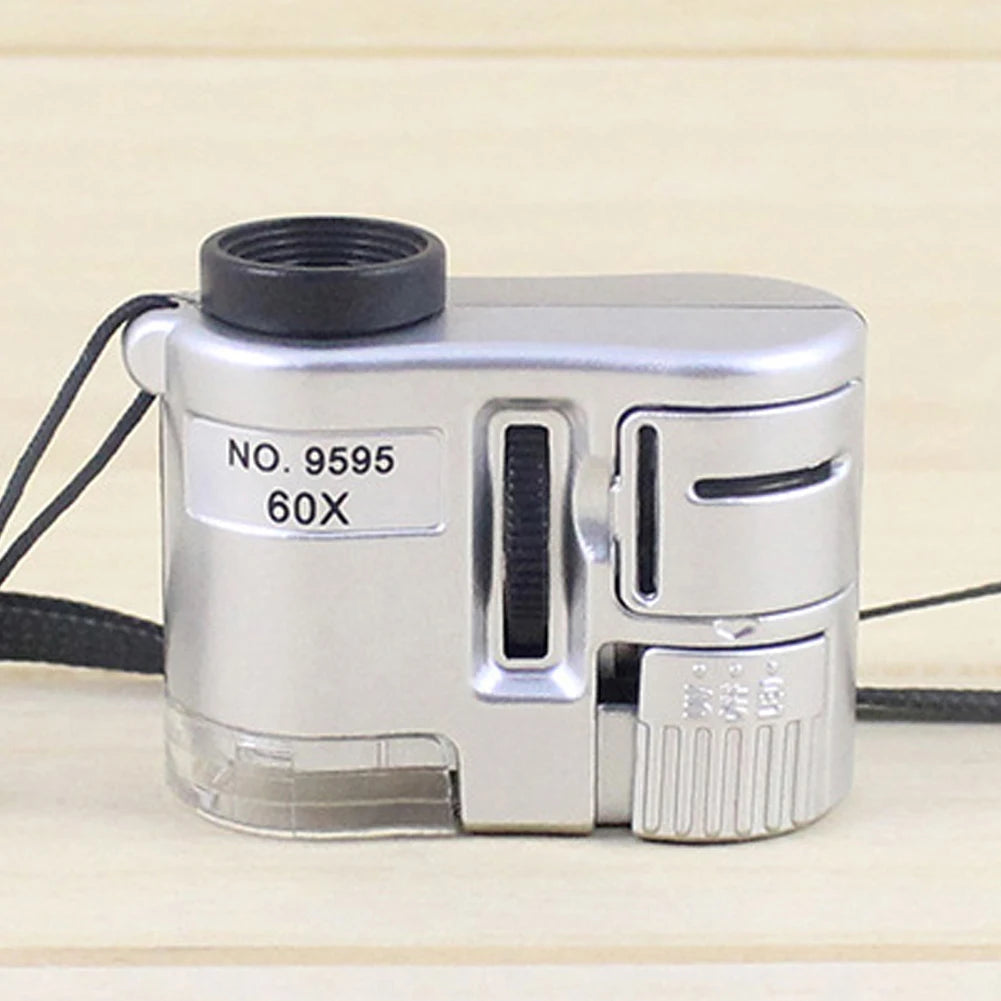 Silver handheld magnifier with a black lens and storage pouch labeled NO. 9595 60X