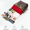 A brown felt tote bag organizer insert with multiple pockets and a red lining shown next to various cosmetic and electronic i