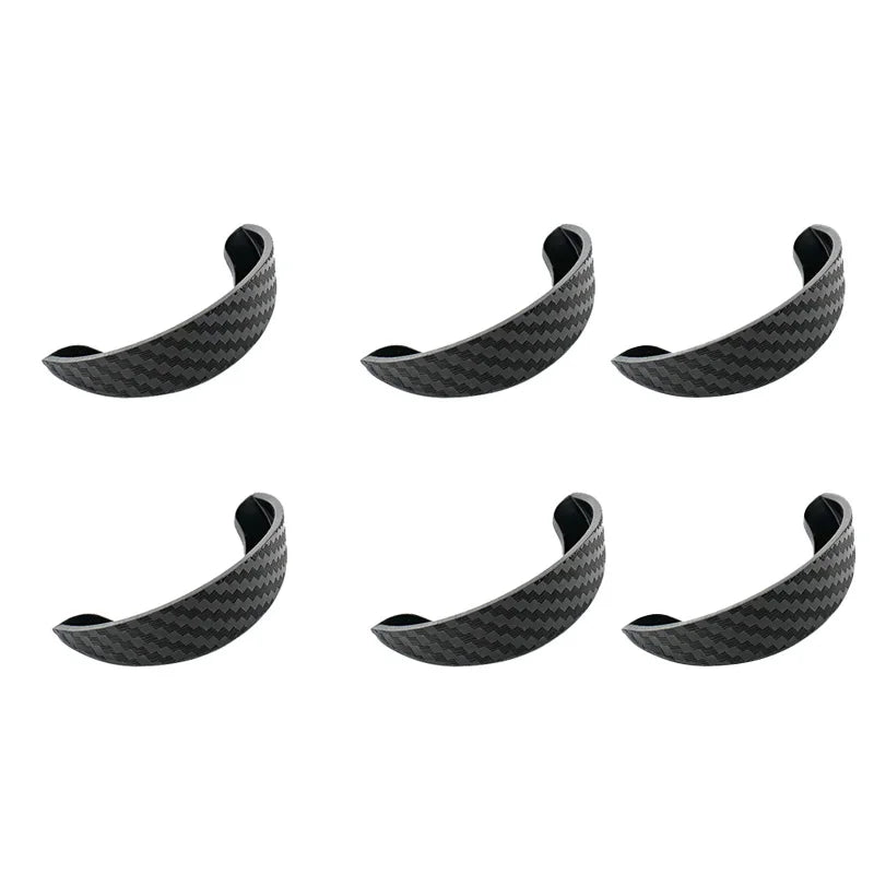A set of black carbon fiber rain covers designed as a visor for car rear cameras.