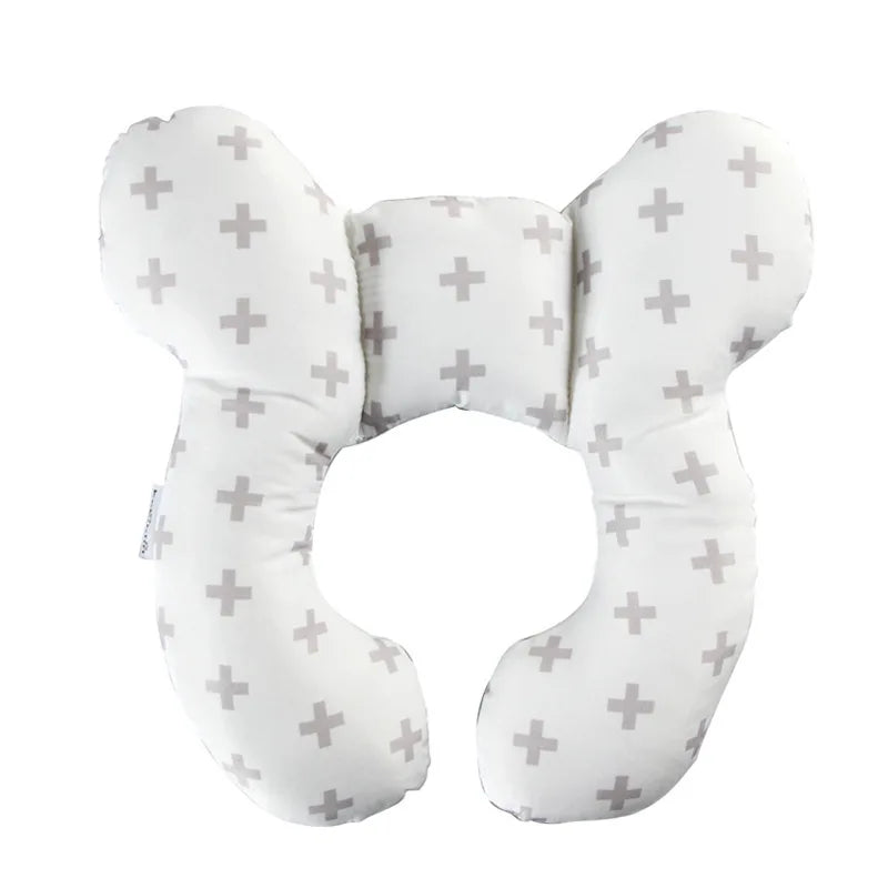 A white baby head and neck support pillow designed for car seats and travel.