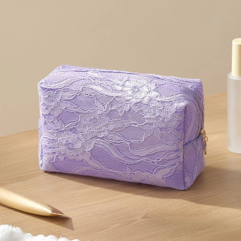 A purple lace mesh makeup bag resting on a wooden surface.