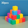 A stack of 30 colorful soft silicone building blocks in various shades of yellow, blue, and pink.