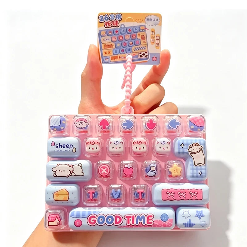 A pink plastic case filled with various colorful cartoon keycap fidget items and a small instruction card is held by a hand.