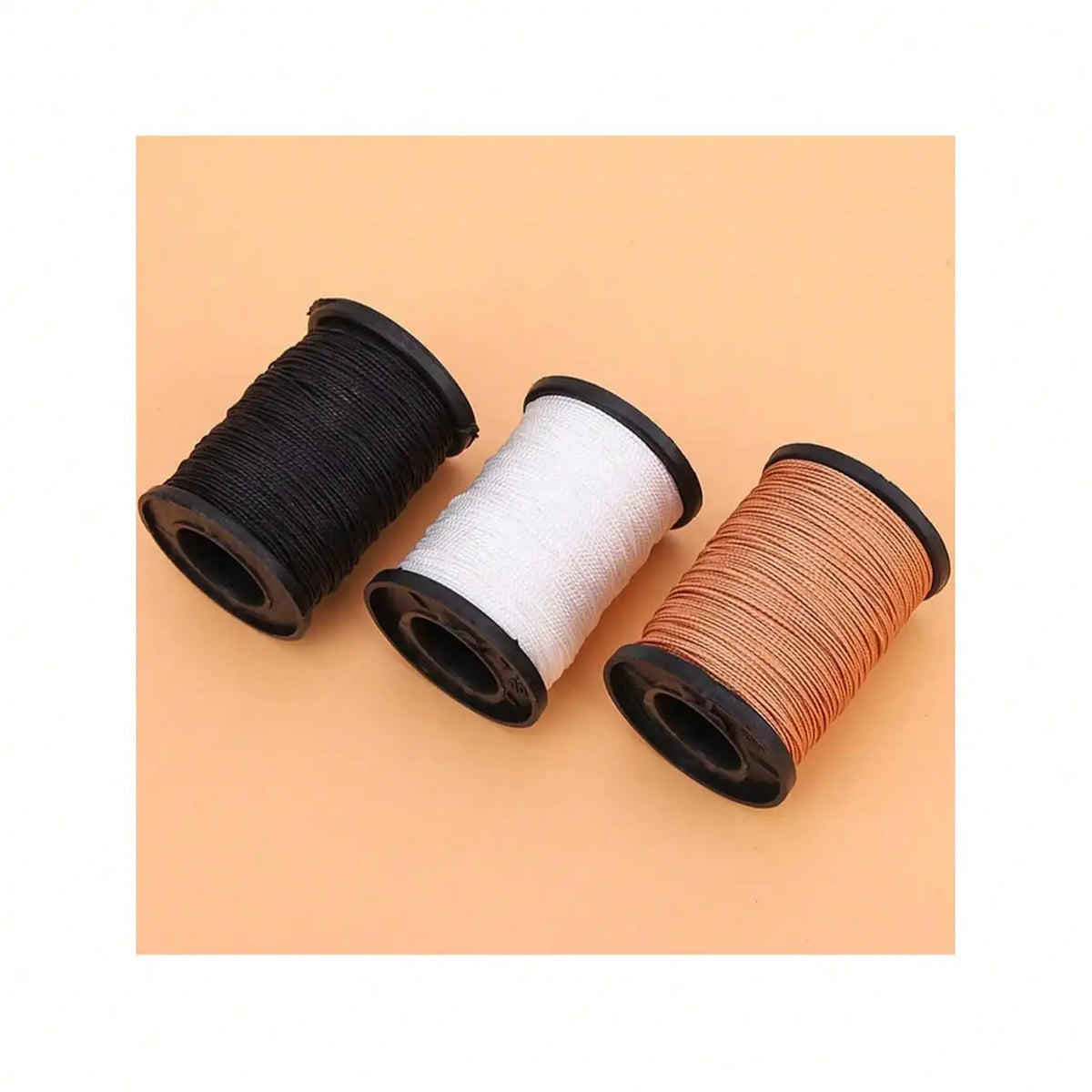 Three spools of heavy-duty waxed nylon thread in black, white, and copper tones.