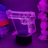 A glowing purple wireframe gun-shaped night light displayed on a dark surface.