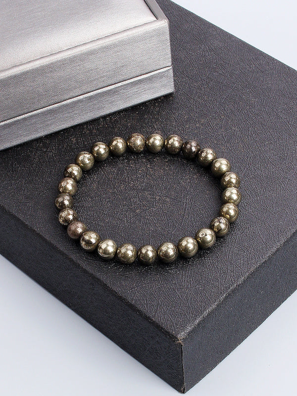 Pulsera de piedra de pirita tono dorado exhibida en una caja negra.