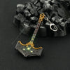 A detailed metal sword keychain with an ornate hilt and a decorative blade, set against a dark background.