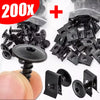 A kit of black self-tapping screws and U-shaped spacers shown next to a hand for scale.