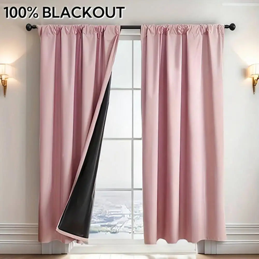 A pair of pink blackout curtains with black accents hanging in a window frame.