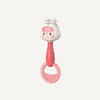 A pink cartoon animal rattle toy with a white head and pink body.