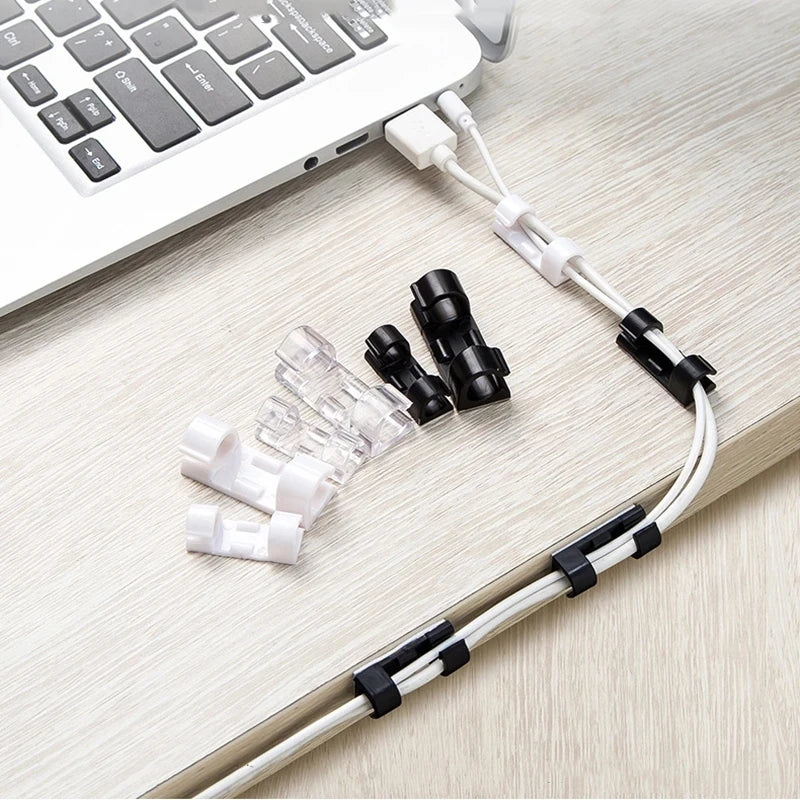 White cable management clips and wires are shown next to a laptop keyboard.