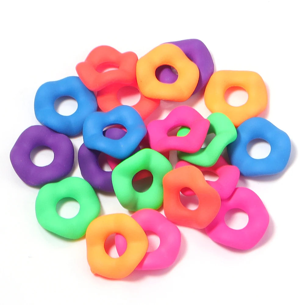 A pile of colorful acrylic spacer beads in various shades including pink, orange, purple, blue, and green.