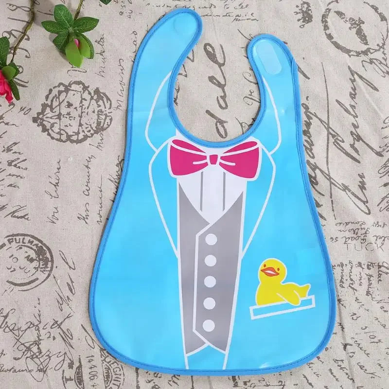 A light blue silicone wipeable baby bib with a pink bow and a yellow duck design for weaning toddlers.