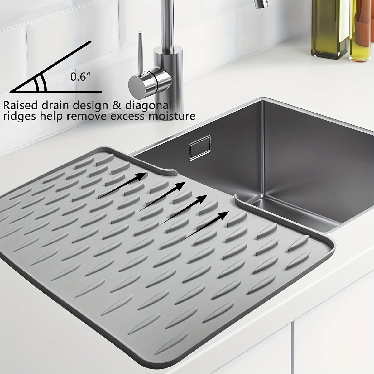 A silicone dish drying mat with diagonal ridges is shown next to a kitchen sink, demonstrating its raised drain design.