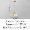 A gold crystal pendant light fixture with an iron frame suspended from the ceiling.