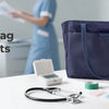 Navy nurse tote bag for busy shifts sitting on a white desk with medical tools.