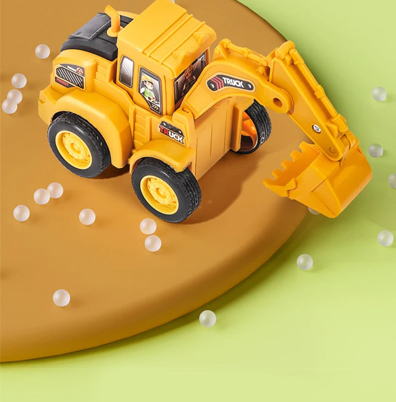 A yellow diecast push-play excavator and bulldozer set resting on a green surface with scattered white balls.