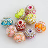 A collection of colorful rhinestone round beads in various shades including pink, yellow, orange, and blue, used for jewelry 