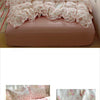 A pink floral duvet cover set with matching pillowcases and a flat sheet displayed on a bed.