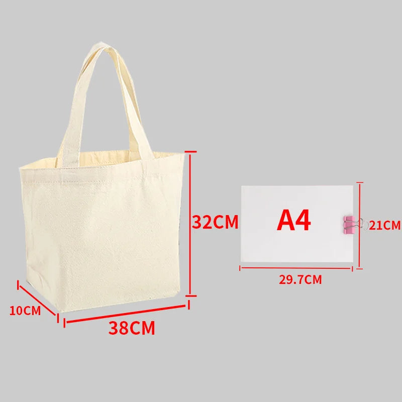 A beige canvas shopping tote bag shown with dimensions and an A4 sized card.