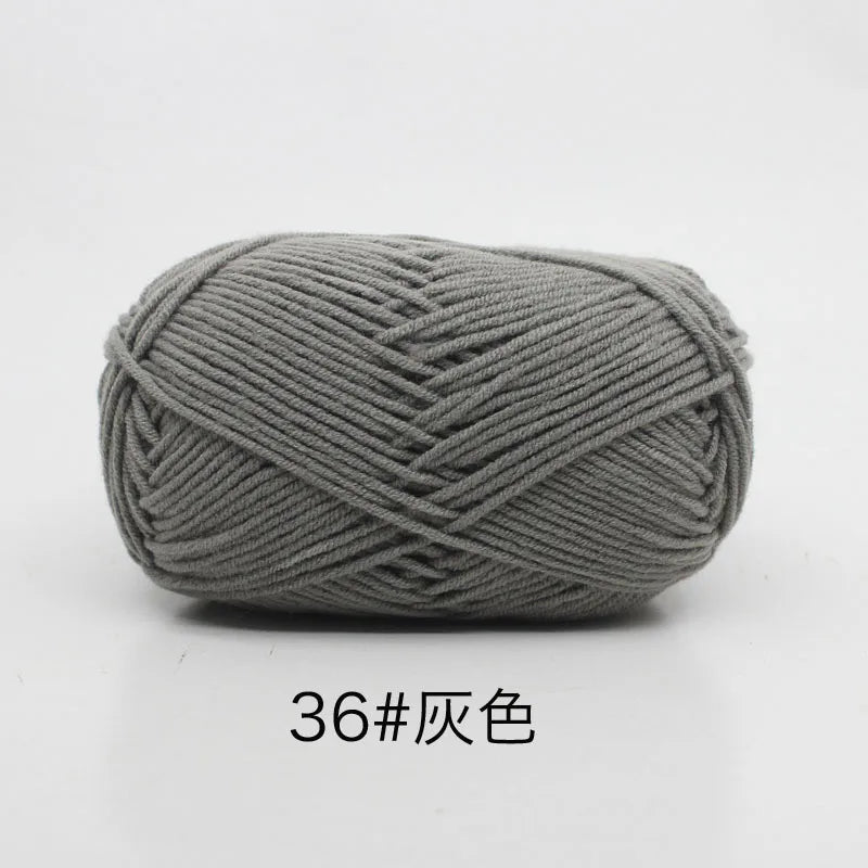 A ball of gray 4-ply milk cotton yarn for knitting and crochet.