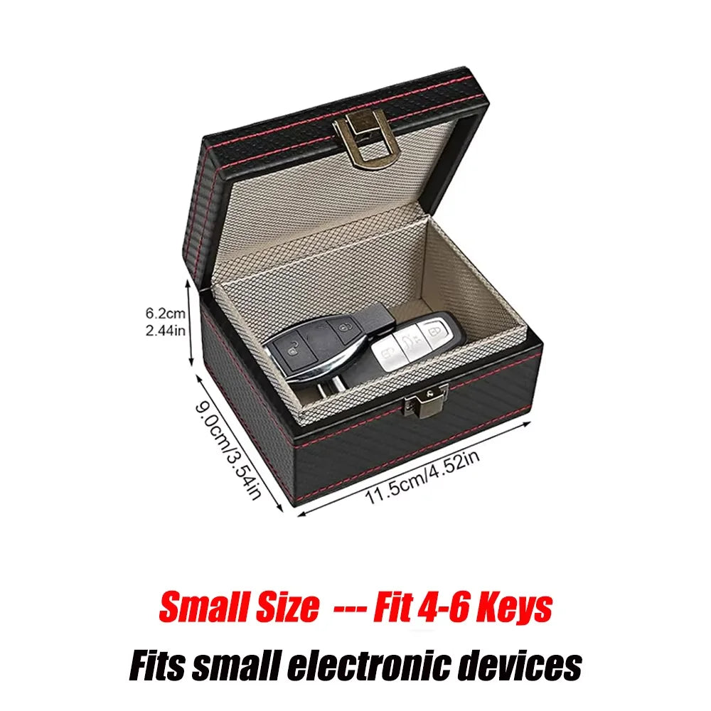 A black carbon fiber box with a lid open, designed to hold small electronic devices like key fobs and phones.