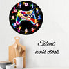 A round wall clock face with numbers and colored stars, featuring a glowing gaming controller design.