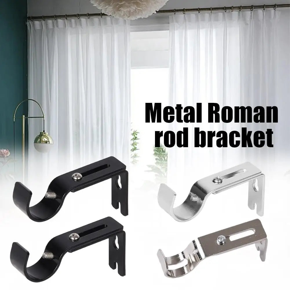 A set of metal Roman rod brackets for curtain rods shown against a white window backdrop.