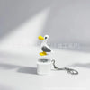 A white seagull figurine keychain fidget toy with an LED light attached to a silver chain.