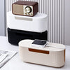 A set of modern cable management boxes in brown, white, and black are displayed on a white desk.