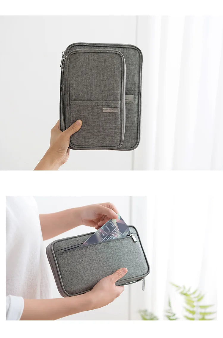 A gray waterproof family passport and document organizer wallet being held by a hand.