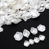 A pile of white acrylic pearl spacer beads for jewelry making.