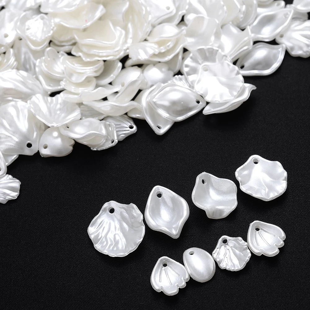 A pile of white acrylic pearl spacer beads for jewelry making.