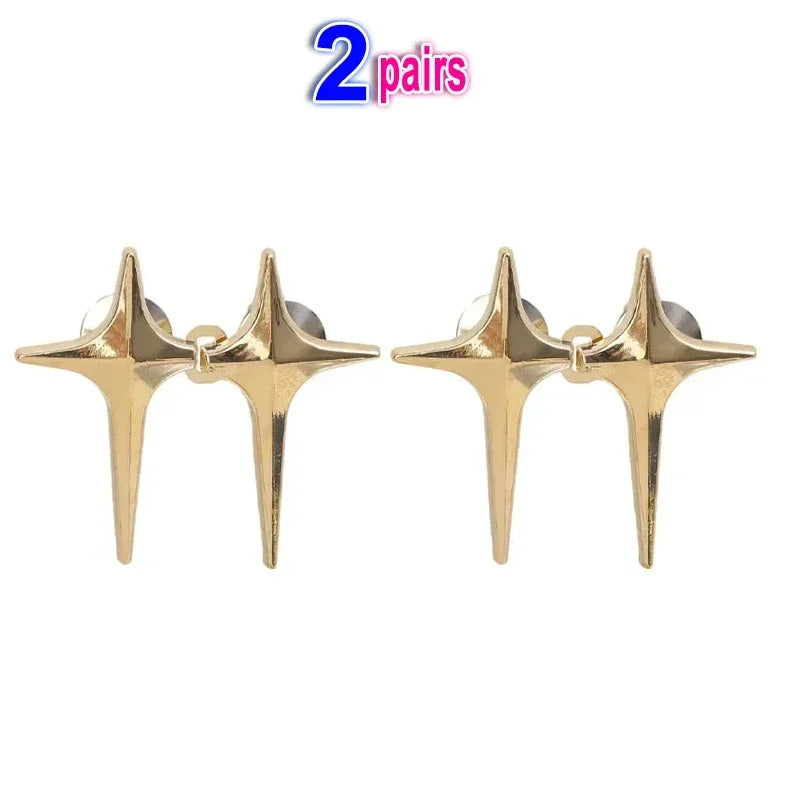 A pair of gold-colored Y2K star waist tightener clips for jeans.