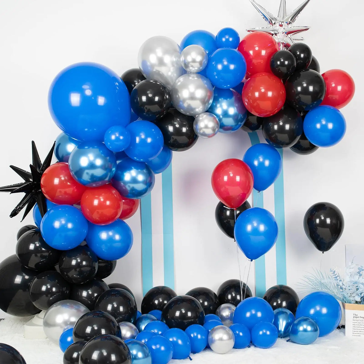 A balloon garland arch featuring blue, red, and black balloons arranged in an arch shape.