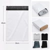 A stack of white self-sealing mailing bags with black sealing strips and a folded t-shirt shown next to them.