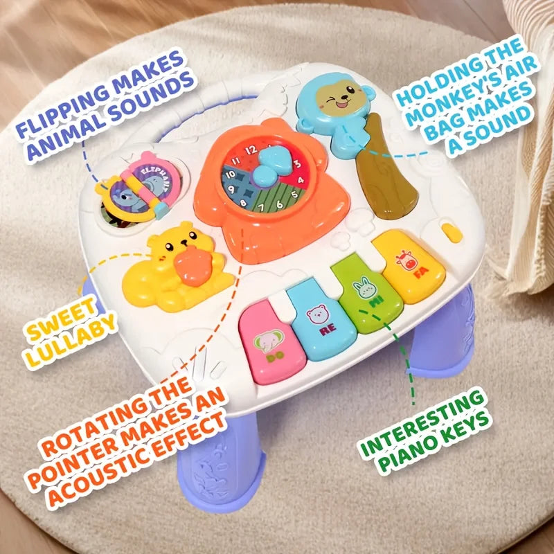 A white interactive baby learning table featuring animal sound buttons and rotating piano keys.