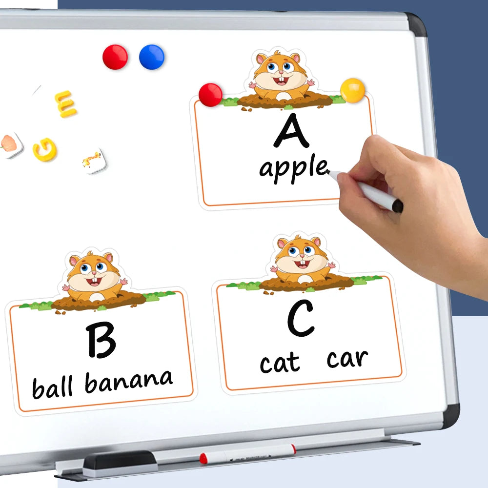 A dry erase board showing letter cards A, B, and C with corresponding fruit, animal, and object pictures for learning