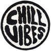 A round black and white letter design featuring the words CHILL VIBES on a fluffy carpet.