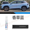 A white automotive touch-up paint pen is shown next to a modern SUV.