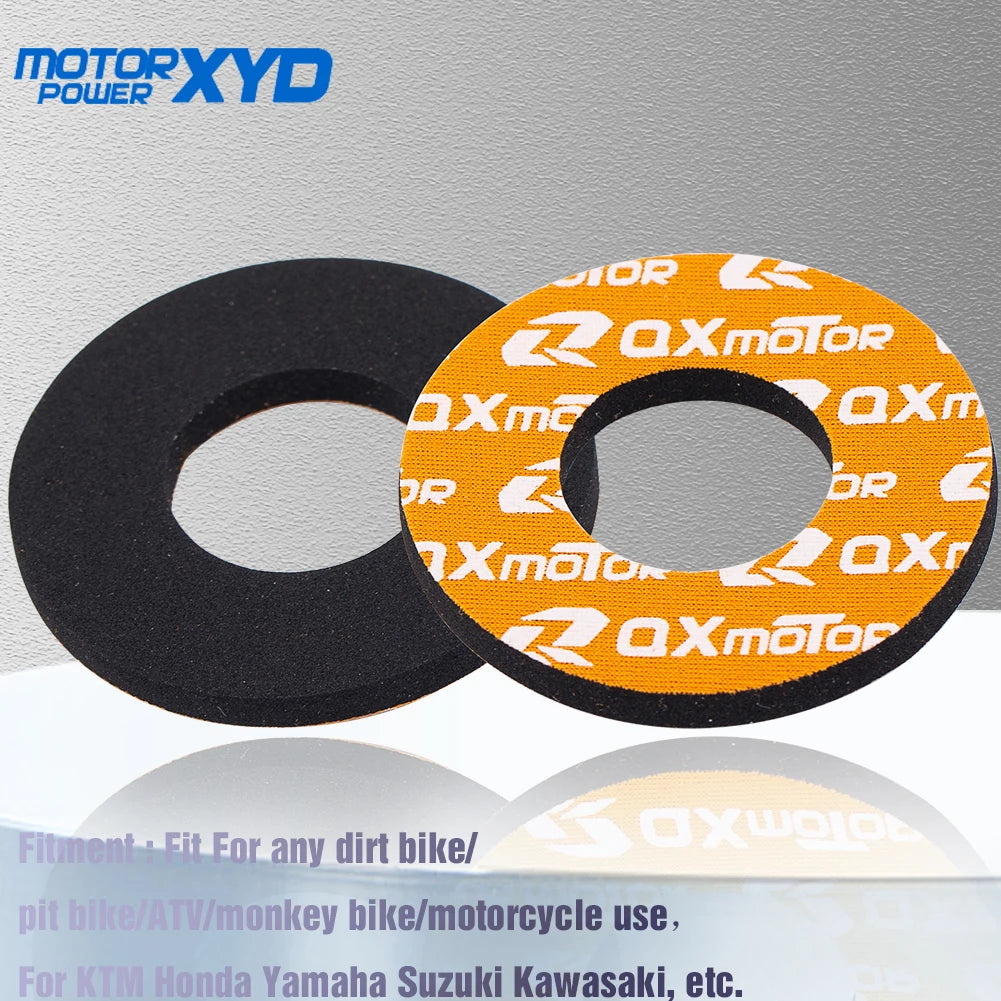 A pair of black and orange handlebar grips for dirt bikes and motorcycles