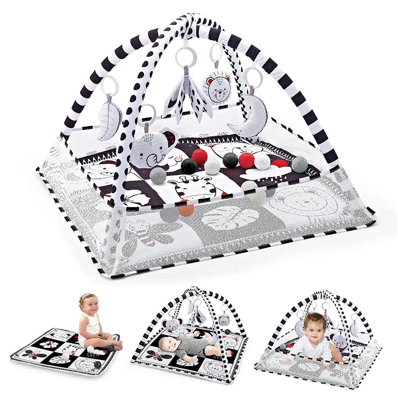 A baby play gym and activity mat with hanging toys featuring a black and white pattern.