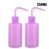 Two purple tattoo squeeze bottles with precision tips and measuring lines